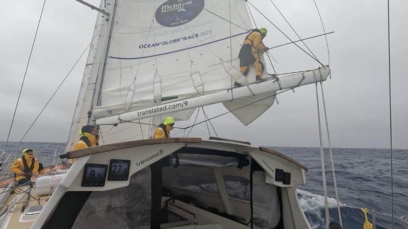 Just because you're in the Southern Ocean doesn't mean you can't climb along the boom to fix a broken batten now does it? - photo © OGR2023 / Translated 9