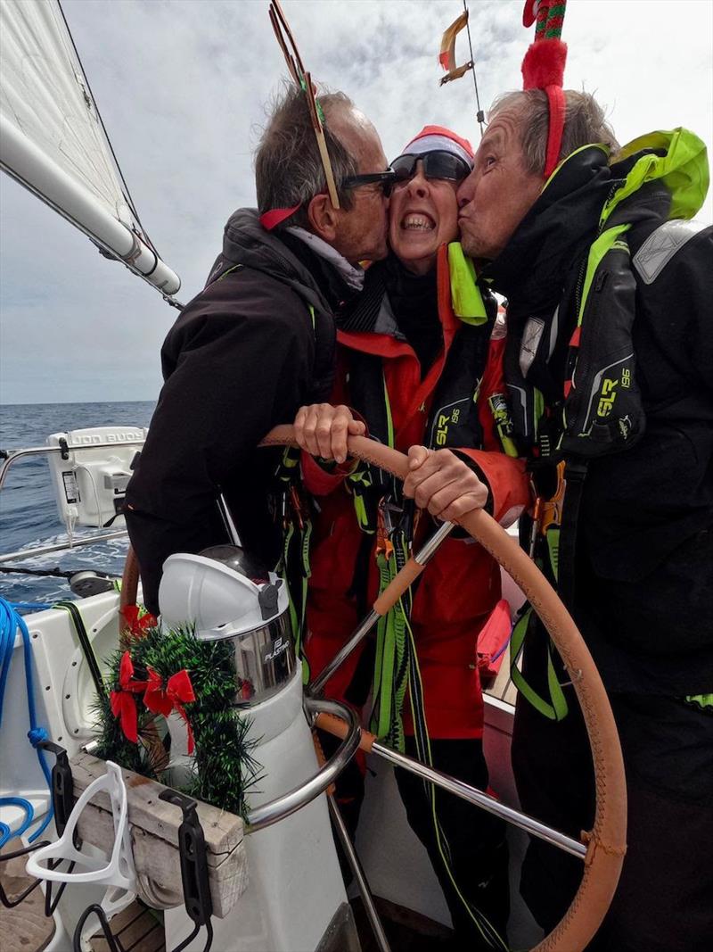 Patrick Bodiou and Benoit Docquet don't let the lack of mistletoe stop them giving Jill Coomber her Christmas kiss onboard Explorer - photo © OGR2023 / Explorer
