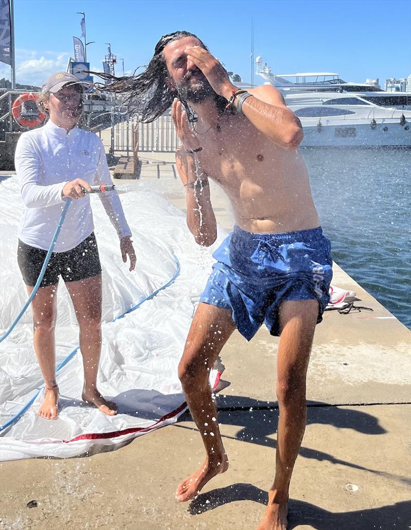 Medhi from Outlaw taking a pontoon shower after checking the sails - Ocean Globe Race - photo © OGR2023 / Jacqueline Kavanagh