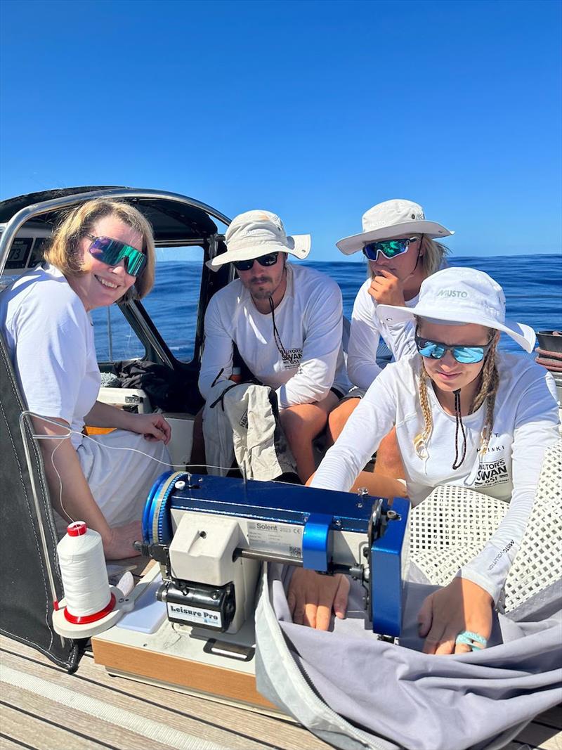 Never a dull moment onboard as Hilla fixes sails under the blazing sun photo copyright OGR2023 / Spirit of Helsinki taken at  and featuring the Ocean Globe Race class