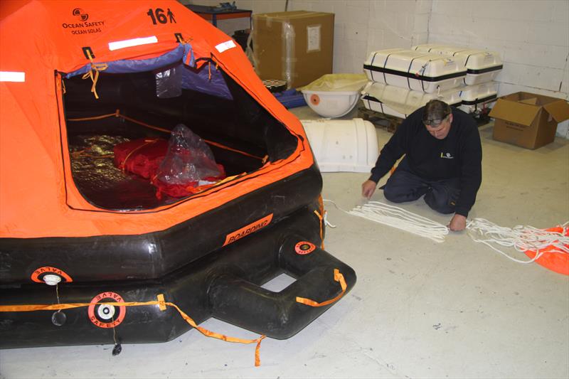 Checking the lines on a Ocean Safety Life Raft photo copyright Mark Jardine taken at  and featuring the  class