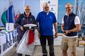 Peter Ramcke, PRO, Jan Prockat, course race officer, presented with a signed flag and half model by Pontus Gäbel from OKDIA - OK Dinghy Europeans at Warnemünde © Robert Deaves / www.robertdeaves.uk