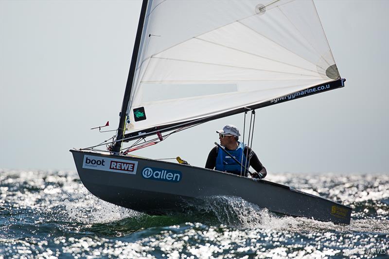 Simon Cox on day 3 of the OK Dinghy European Championship in Kiel, Germany photo copyright Robert Deaves taken at  and featuring the OK class