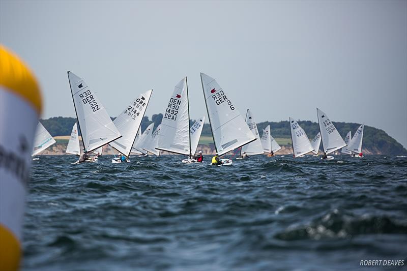 Downwind in Race 6 on day 3 of the OK Dinghy European Championship in Kiel, Germany photo copyright Robert Deaves taken at  and featuring the OK class