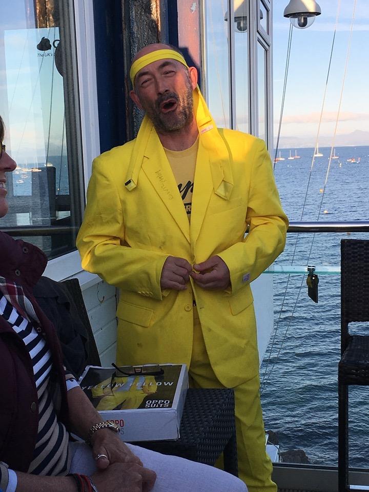 Ian Harris claiming the 'Dick of the Day' Yellow suit for capsizing onto the committee boat during the OK Nationals at Abersoch photo copyright Sue Byers taken at South Caernarvonshire Yacht Club and featuring the OK class