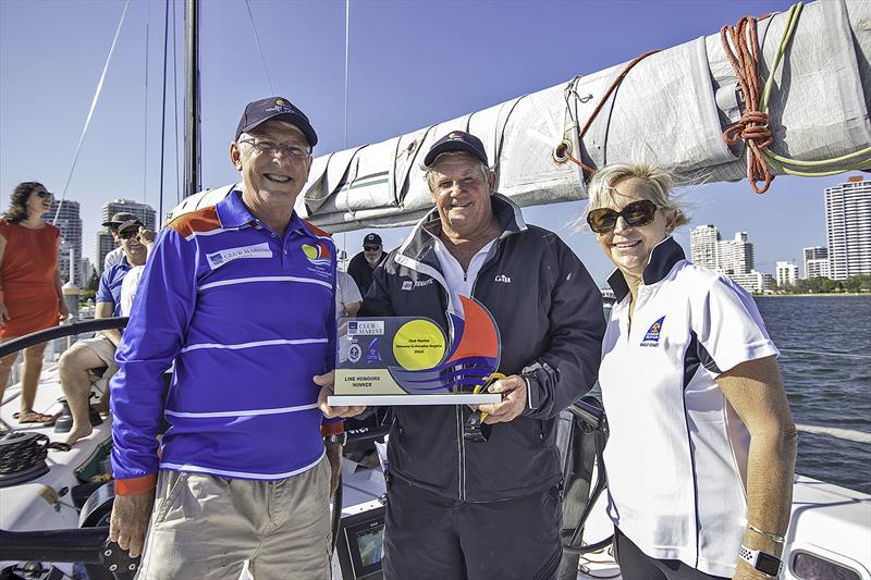Mick Martin very happy to get his hands on the Line Honours trophy photo copyright Southport Yacht Club taken at  and featuring the OK class