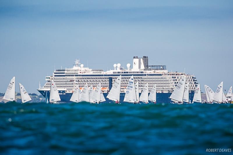 The fleet was joined by a departing cruise ship - Symonite OK Worlds, Day 2 photo copyright Robert Deaves taken at Wakatere Boating Club and featuring the OK class