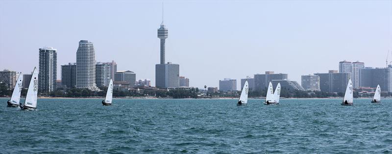 OK fleet upwind with the Pattaya skyline on day 3 of the Royal Varuna Yacht Club Open Masters Championship 2026 photo copyright Henry Weidmann taken at Royal Varuna Yacht Club and featuring the OK class