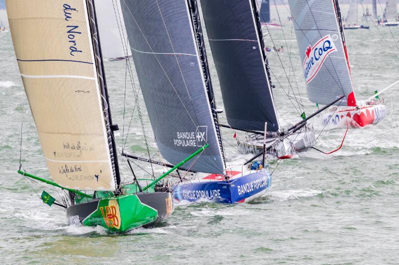 Twenty IMOCA 60s at the start of the Rolex Fastnet Race photo copyright Rolex / Carlo Borlenghi taken at Royal Ocean Racing Club and featuring the IMOCA class