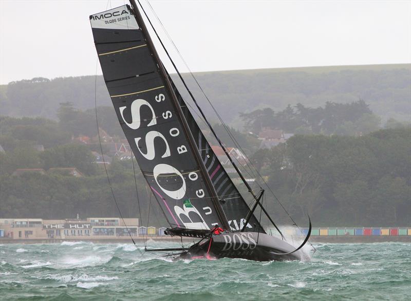 Hugo Boss passes Hurst Castle after the Rolex Fastnet Race start photo copyright Mark Jardine taken at Royal Ocean Racing Club and featuring the IMOCA class