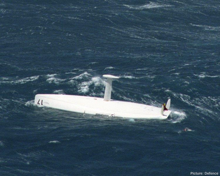 Thierry Dubois stands waiting to be rescued aboard a slowly sinking Open 60, Amnesty International, in the Southern Ocean. Tony Bullimore was resucued later in the day by the same rescue ship. - photo © Australian Defence