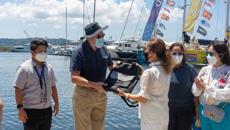 Sir Robin Know-Johnston receiving a gift from Maria Anthonette Velasco-Allones. Gifts were given to all crew on board prior to departure - Clipper Race - photo © Clipper Race