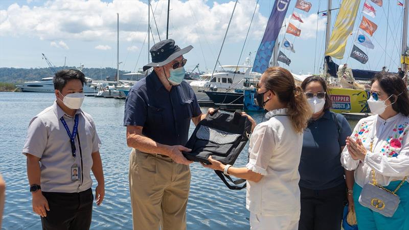 Sir Robin Know-Johnston receiving a gift from Maria Anthonette Velasco-Allones. Gifts were given to all crew on board prior to departure - Clipper Race photo copyright Clipper Race taken at  and featuring the IMOCA class