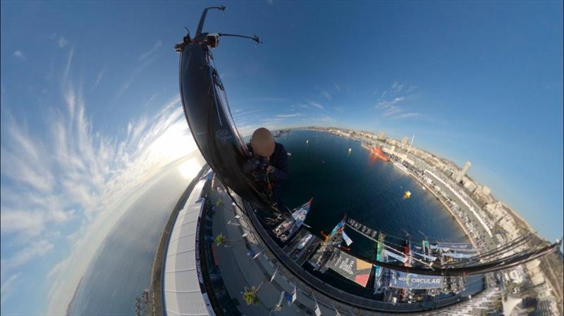 Fred Buyle climbs 90ft mast of 11th Hour Racing Team's boat 'Malama' photo copyright Fred Buyle taken at  and featuring the IMOCA class