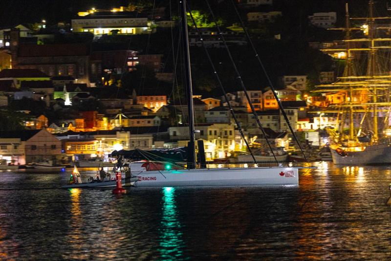 Assisted by the Port Louis Marina team, IMOCA 60 Canada Ocean Racing makes her way through St George's Carenage to a great welcome on the dock - RORC Transatlantic Race - photo © Arthur Daniel / RORC