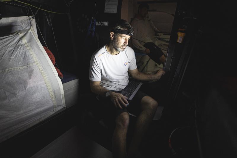 Onboard 11th Hour Racing Team during The Ocean Race Leg 2, Day 14. Simon Fisher downloading new weather at the nav station - photo © Amory Ross / 11th Hour Racing / The Ocean Race