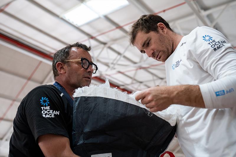 Skipper Benjamin Dutreux (right) and Jimmy le Baut examine the sail head of the nylon gennaker - photo © Gauthier Lebec / GUYOT environnement - Team Europe