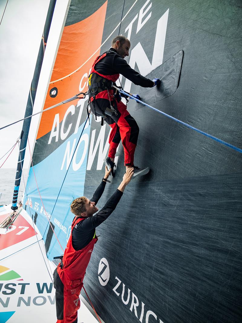 Nicolas Lunven two metres in the air supported by Will Harris in order to complete the J2 repair - The Ocean Race - photo © Antoine Auriol/Team Malizia