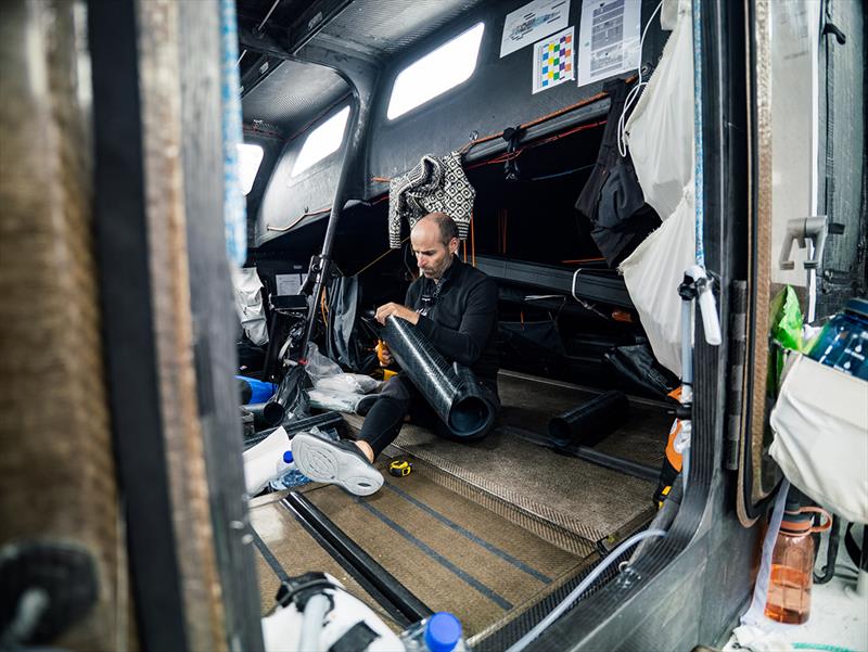 Nico Lunven preparing the patch to cover the rip in the J2 sail - The Ocean Race - photo © Antoine Auriol/Team Malizia