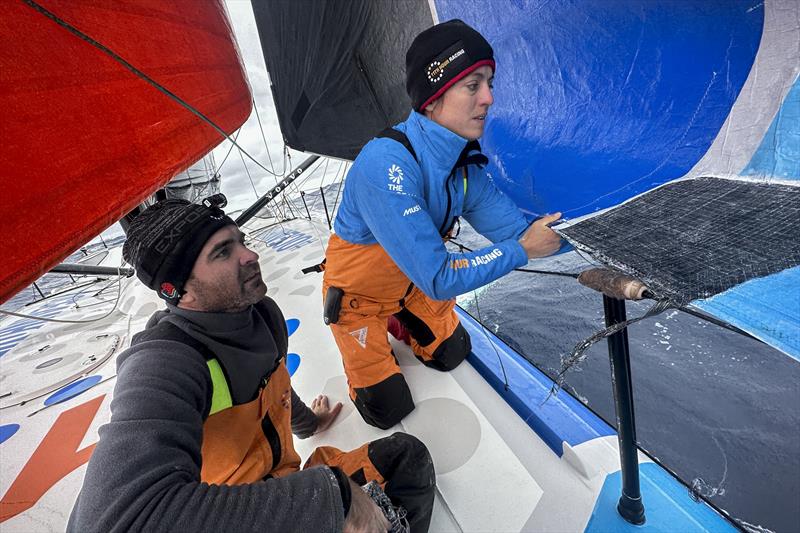 The Ocean Race 2022-23 Leg 3, Day 8 onboard 11th Hour Racing Team, Justine Metttraux and Charlie Enright checking on the J2 repair and stanchion upgrade while on the bow photo copyright Amory Ross / 11th Hour Racing / The Ocean Race taken at  and featuring the IMOCA class