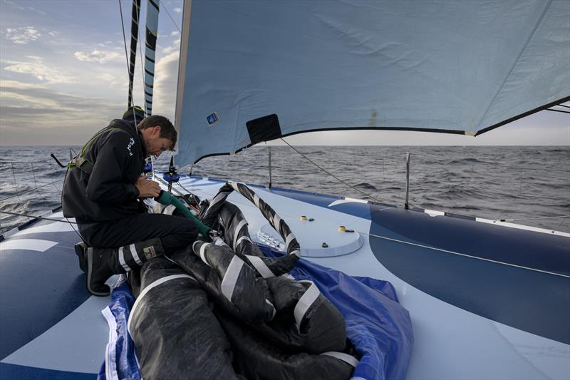 The Ocean Race 2022-23 Leg 3, day 16 onboard Biotherm, skipper Paul Meilhat folding a sail onboard - photo © Ronan Gladu / Biotherm