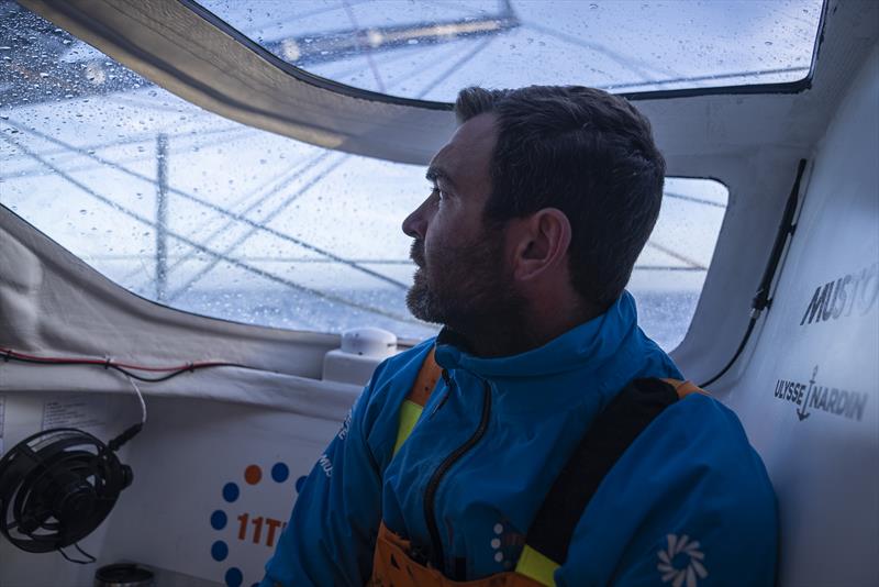 The Ocean Race 2022-23 Leg 3 onboard 11th Hour Racing Team. Charlie Enright in the leeward bubble checking the triune of the jib photo copyright Amory Ross / 11th Hour Racing / The Ocean Race taken at  and featuring the IMOCA class