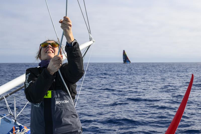 The Ocean Race 2022-23 Leg 3, Day 21 onboard Biotherm. Sam Davies hoist the sail with Team Malizia in the background photo copyright Ronan Gladu / Biotherm / The Ocean Race taken at  and featuring the IMOCA class