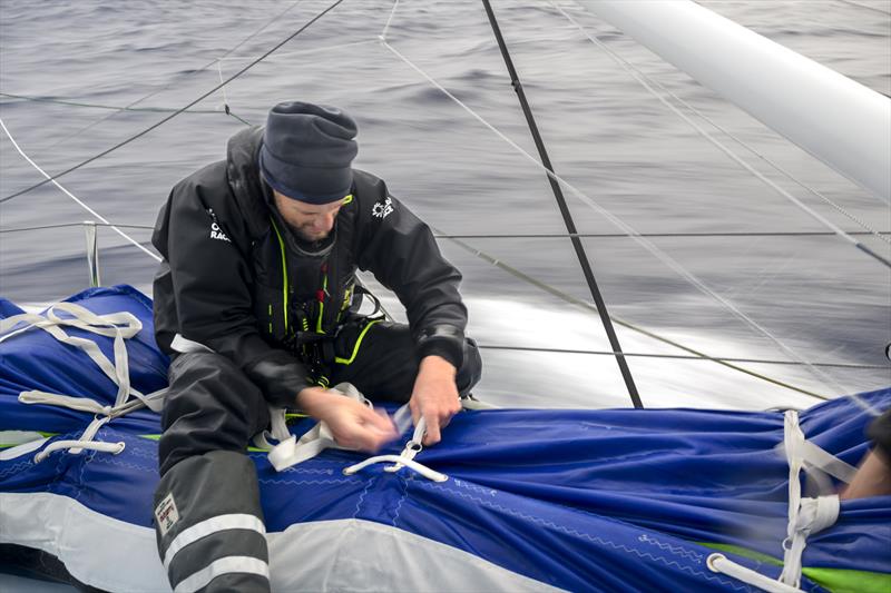 The Ocean Race 2022-23 Leg 3 onboard Biotherm. Skipper Paul Meilhat packing a sail in its bag photo copyright Ronan Gladu / Biotherm / The Ocean Race taken at  and featuring the IMOCA class