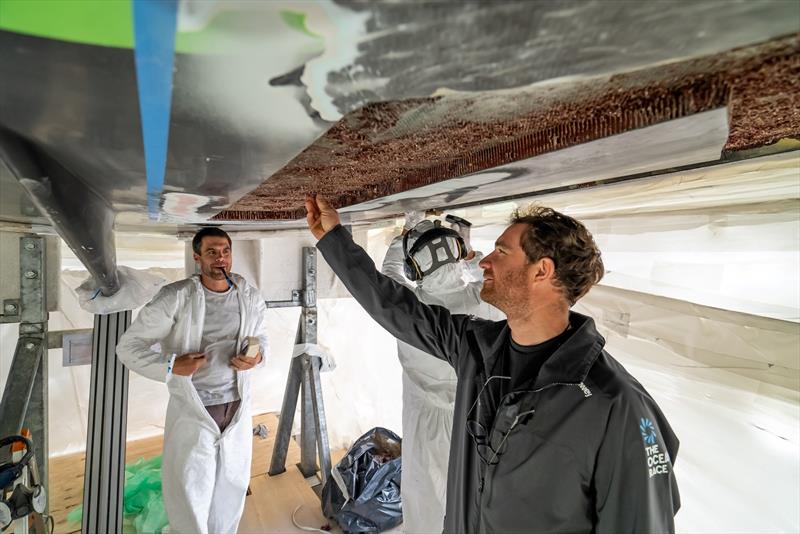 The Ocean Race 2022-23 - 4 March , Leg 3. GUYOT environnement - Team Europe skipper Benjamin Dutreux works on the hull repair replacing the Nomex material - photo © Charles Drapeau / Guyot environnement - Team Europe