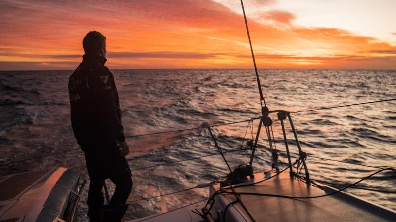 The Ocean Race 2022-23 - 30 March 2023, Leg 3 Day 32 onboard Team Malizia. Will Harris enjoys the beauty of the Atlantic sunset on deck - photo © Antoine Auriol / Team Malizia / The Ocean Race