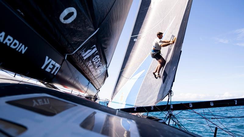 The Ocean Race 2022-23 - 26 April 2023, Leg 4 Day 3 onboard 11th Hour Racing Team. Charlie Enright fixing a small tear in the J2 while it's high and dry photo copyright Amory Ross / 11th Hour Racing / The Ocean Race taken at  and featuring the IMOCA class