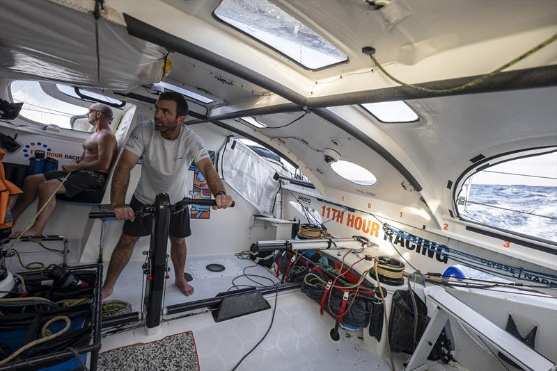 The Ocean Race 2022-23 - 2 May , Leg 4, Day 9 onboard 11th Hour Racing Team. Damian Foxall in the driving bubble with Charlie Enright grinding the mainsail - photo © Amory Ross / 11th Hour Racing / The Ocean Race