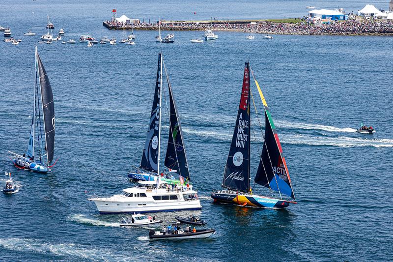 The fleet of IMOCA race yacht with the many spectators watching both from land and out on the water - photo © Sailing Energy / The Ocean Race