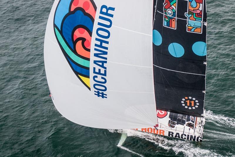 11th Hour Racing Team's vibrant IMOCA 60 sailing off the coast of Concarneau, France - photo © Amory Ross / 11th Hour Racing