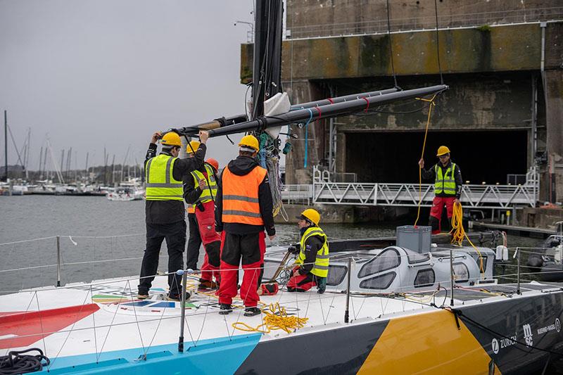 Craning and installing the mast, boom, and outriggers back on the boat is a delicate operation which requires well-executed coordination by the tech team - photo © Marie Lefloch / Team Malizia