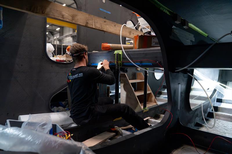 Connor Banks installing the electronics on Team Malizia's new IMOCA as electrification work accelerates with six weeks to go - photo © Flore Hartout | Team Malizia