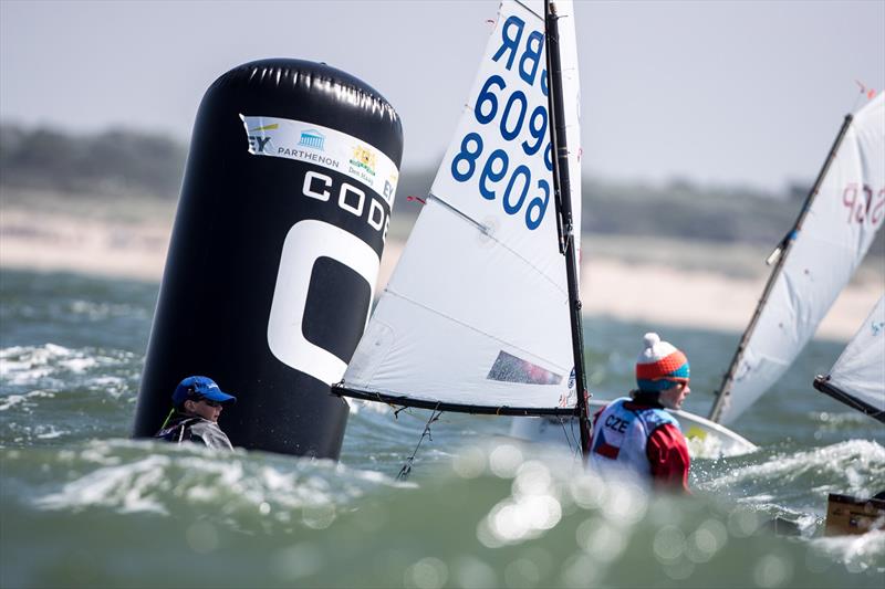 George Creasy working his way through to gain his place into the Gold Fleet at the Optimist Europeans 2018 photo copyright Sander van der Borch / CODE-ZERO taken at Jachtclub Scheveningen and featuring the Optimist class