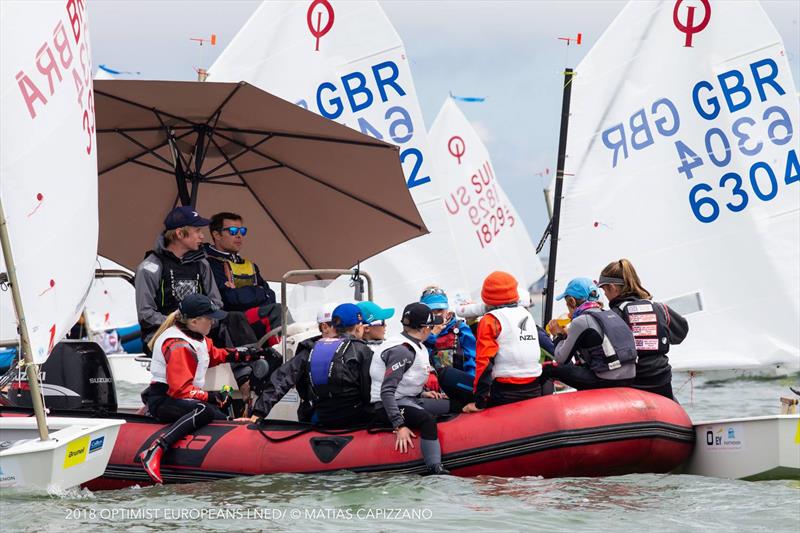 Lovely camaraderie on the water at the Optimist Europeans 2018 - photo © Matias Capizzano