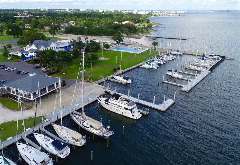 Pensacola Yacht Club is proud to host its third set of Optimist National Championship regattas. The Watson Sailing Center (L), the clubhouse and world's favorite bar, the pool and beach— all 22 acres- will be bustling with young sailors for the 8-day photo copyright Talbot Wilson taken at Pensacola Yacht Club and featuring the Optimist class