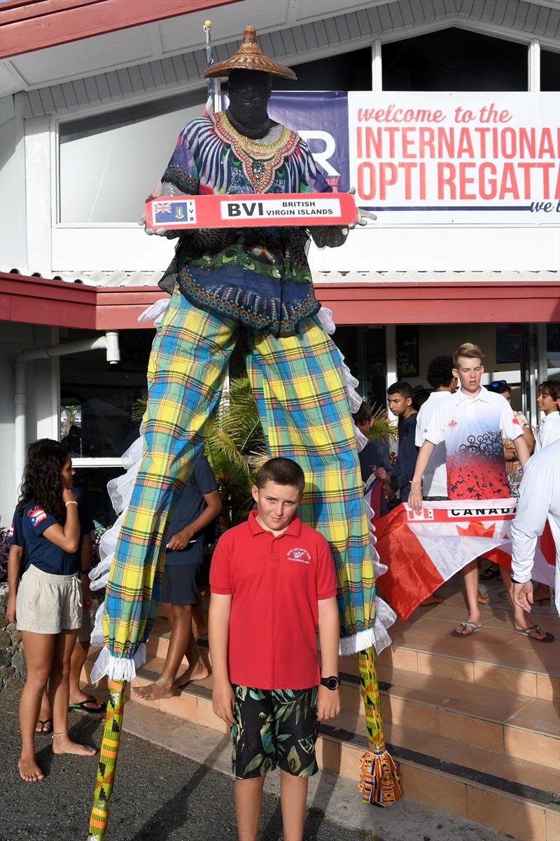 The BVI's Samuel Allen stands with a Mocko Jumbie (stilt-walker) in front of the St. Thomas Yacht Club photo copyright Dean Barnes ? taken at St. Thomas Yacht Club and featuring the Optimist class