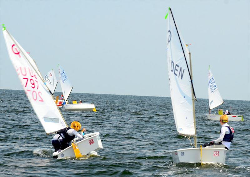 Stephan Baker of Miami (L) threw a lee bow tack on Malthe Ebdrup of Denmark in the final upwind leg today to break  Ebdrup's cover and took the lead. Baker came out ahead of Ebdrup after seven races by three points photo copyright Talbot Wilson taken at Pensacola Yacht Club and featuring the Optimist class