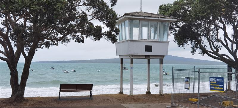 Sizeable surf in front of the Memorial start tower - constructed in 1960 by the Club in memory of the 10 Club sailors who lost their lives in World War 2 - Wakatere BC - Optimist and Starling Auckland Championships - February 5, 2022 photo copyright Richard Gladwell - Sail-World.com/nz taken at Wakatere Boating Club and featuring the Optimist class