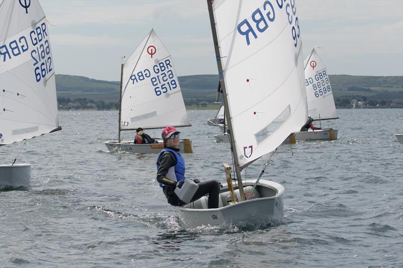 Lymington Optimist Open winner Archie sailing and bailing - photo © Adam Gosling