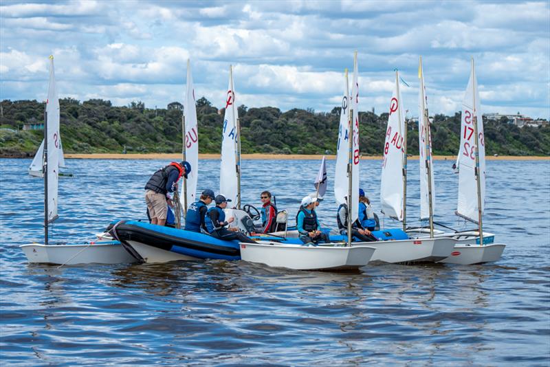 Optimist sailors raft up with their coach after a very light opening race - Sail Sandy Regatta 2022 - photo © Jordan Roberts