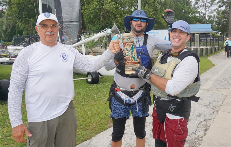 Larry Wagner, Commodore, presents the ritual mug of beer to Pete Hampshire and skipper Eric Roberts, winner of the 69th Mug Race - photo © Image courtesy of the Mug Race