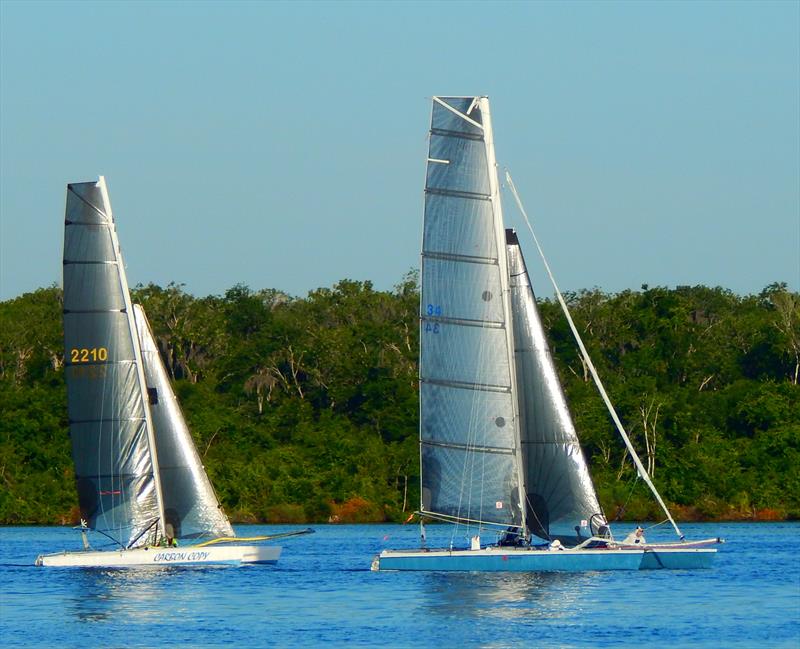 An Aquarius Roberts Catamaran 22 (ARC 22, left) and a Roberts Catamaran 27 (RC27, right) search for breeze in the early morning of the 67th annual Mug Race - photo © The Mug Race