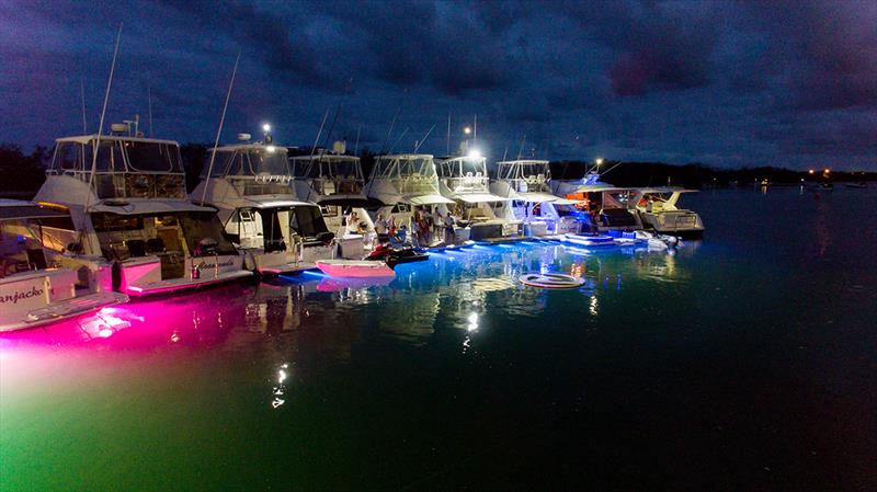 Underwater lights add to the festive atmosphere of the 26 Riviera motor yachts in the Gold Coast raft-up. - photo © Riviera
