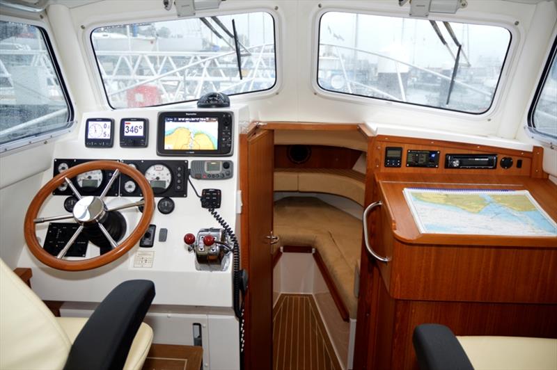 Pilothouse detail showing steering position, chart table and entry to the forward cabin photo copyright Barry Pickthall / PPL taken at  and featuring the Power boat class