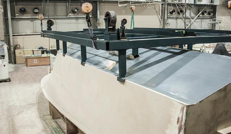 The metal cradle is lowered onto the hull plug to ensure a perfect fit for the completed hull. The cradle will be used to move the hull and, eventually, the entire motor yacht, between fitout stations during the build photo copyright Riviera Australia taken at  and featuring the Power boat class