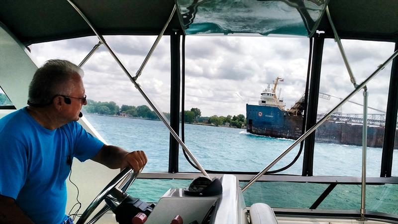 Great Lakes Cruising Club port captain Jim Ehrman watches the commercial ships in Lake Erie from the helm of his 44-foot Carver motorcruiser, La Dolce Vita photo copyright Janice Vitucci-Ehrman taken at  and featuring the Power boat class